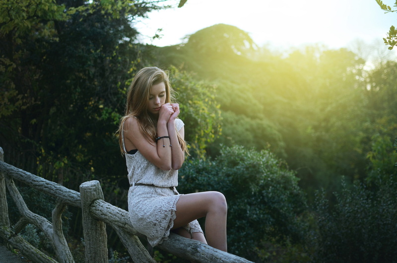 Beautiful, Pose, slender, Hip, fence, Legs, dress, hips, sitting, the sun, summer, jungle, light, Cute, sun, the fence, Girl, face, view, Figure, Park