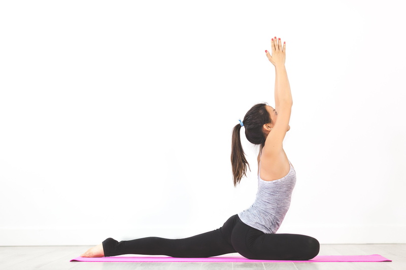 arms raised, yoga, black, sports clothing, lifestyles, pants, gray, fitness, one person, leisure activity, mat, exercising, meditation, lifestyle, physical activity