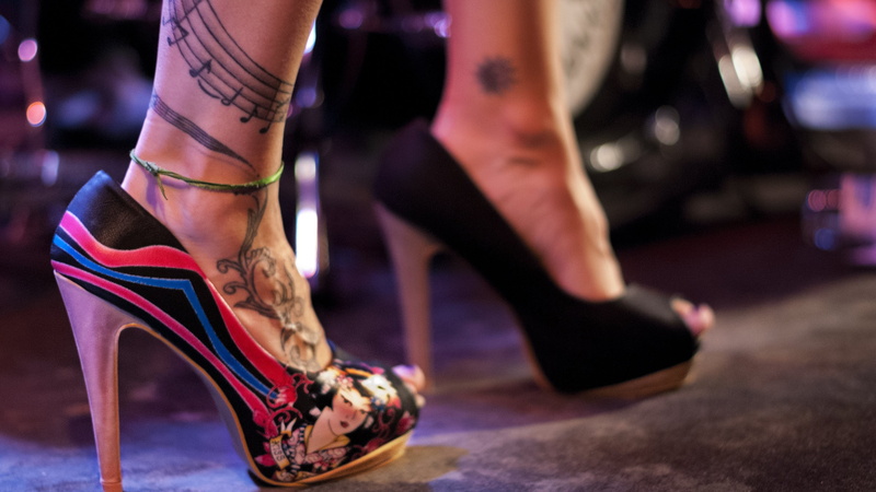 red, low section, human leg, stuff, indoors, focus on foreground, nightlife, stage, human body part, body part, limb, stiletto, stage - performance space