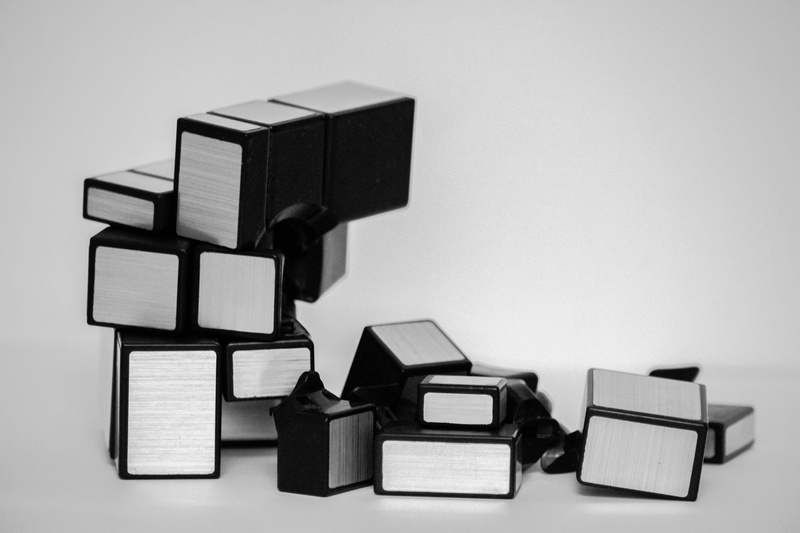 connection, black color, cube, toy, rubiks cube, indoors, cube shape, rubik, block, gray background, broken stuff, copy space, table, geometric shape, pieces