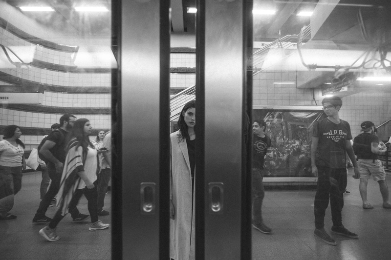 standing, adult, illuminated, photography, facial expression, people, architecture, transportation system, full length, grayscale, indoors, subway train