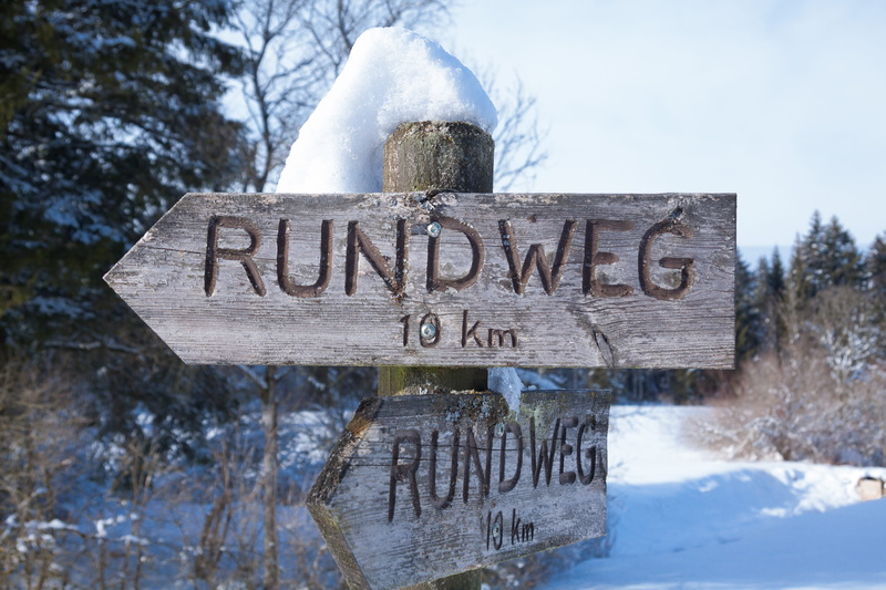 communication, winter, trees, cold temperature, tree, no people, directory, wood - material, snow, hill, flowing water, sign, flatly, focus on foreground