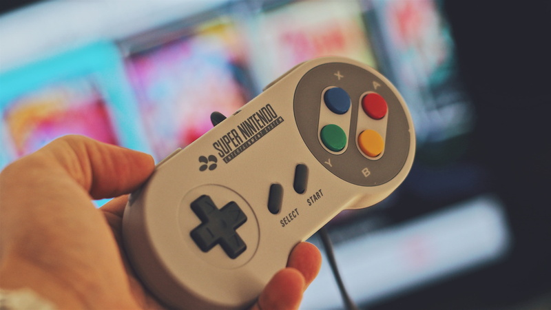 selective focus, arts culture and entertainment, close-up, one person, finger, indoors, body part, play, screen, human hand, text, game controller, portable
