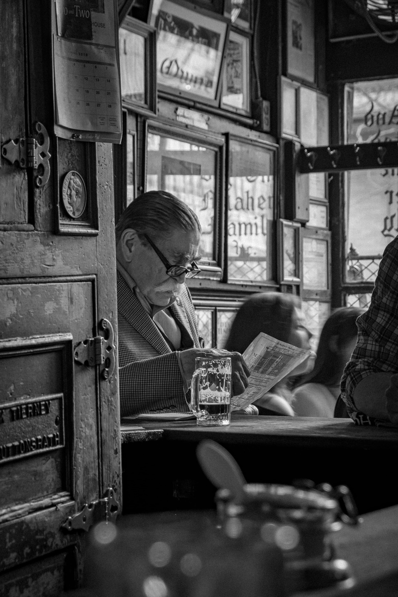 bar, lifestyles, elder, new york, greyscale, old man, males, sitting, reading, nostalgium, waist up, indoors, glass, glasses, leisure activity, man, window