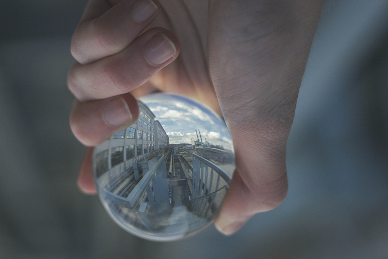 outdoors, transparent, human body part, wealth, ball, responsibility, clear, decor, glass - material, spherical, precious gem, coin, industrial, display