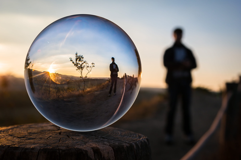 close-up, focus on foreground, ball, 5K, taking photo, focus, sphere, perspective, wood - material, transparent, men, selective, reflection, standing