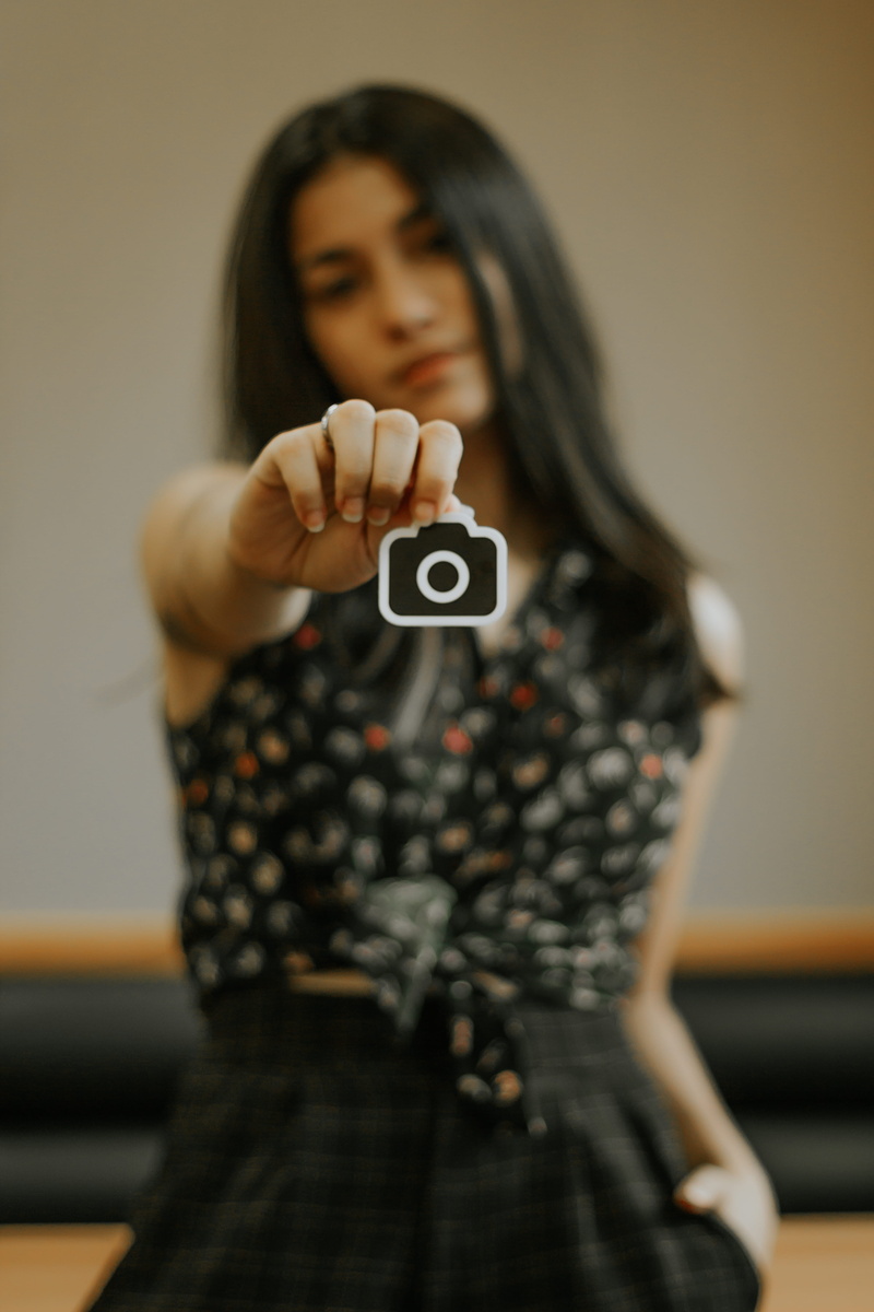 goblet, sticker, young women, indoors, text, human, one person, adventure, real people, hardwood, face, hairstyle, rubix cube, focus on foreground, adult