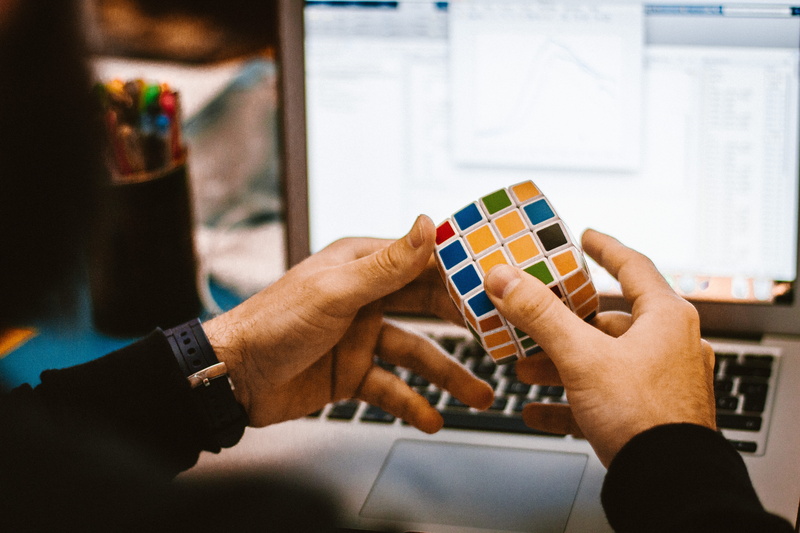 pc, holding, game, leisure activity, recreational, table, business, blur, day, hobby, adult, choice, distraction, cube, creativity, sitting, hands, human hand