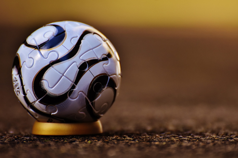 toys, indoors, fun, soccer ball, puzzle ball, selective focus, white, gold colored, ball, football, sports equipment, globe - man made object, stand, sport