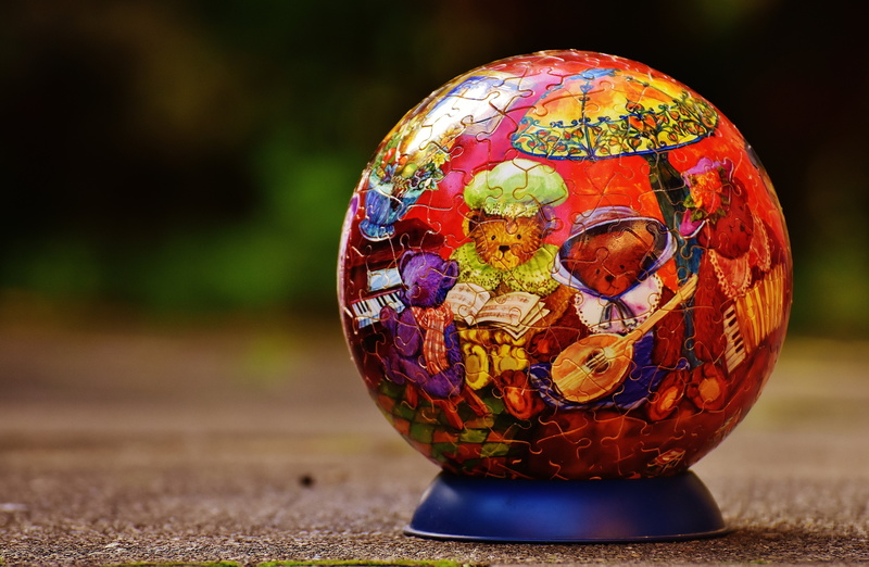 single object, multi colored, no people, craft, religion, tricky, puzzle, puzzle ball, red, stand, globe - man made object, outdoors, planet - space, close-up