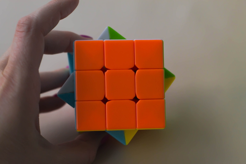 one person, multi colored, palm, close-up, 4K, indoors, cube shape, unrecognizable person, body part, cube, abstract, puzzle, red, game, brain, human limb