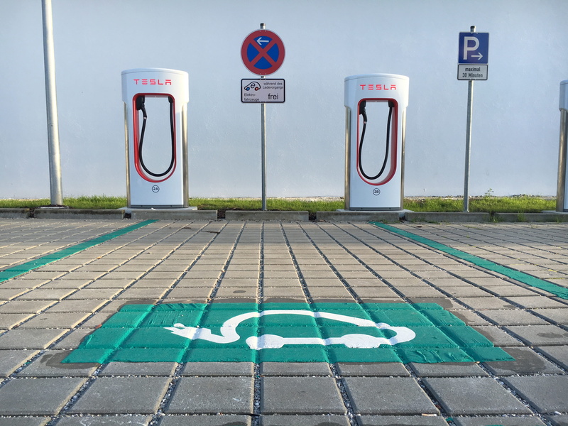 sign, supercharger, western script, disabled sign, road marking, information sign, symbol, communication, outdoors, information, road, tesla, text, representation
