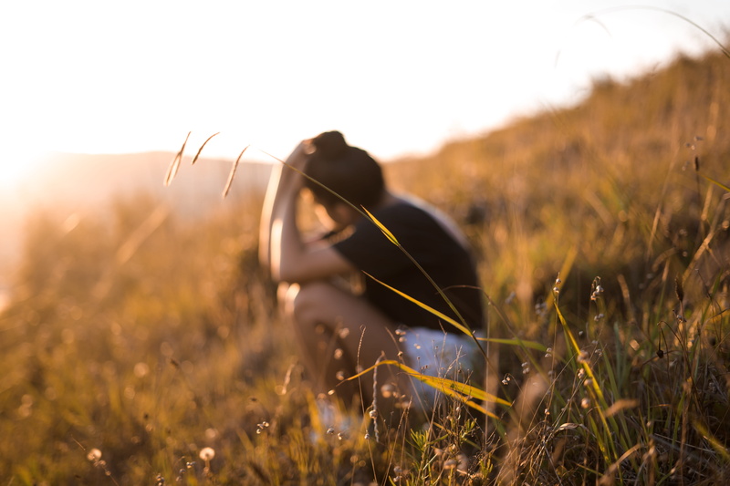 non-urban scene, land, day, countryside, face, crouching, human, photography, selective focus, grass, nature, one animal, grassland, sunset, valleys, field