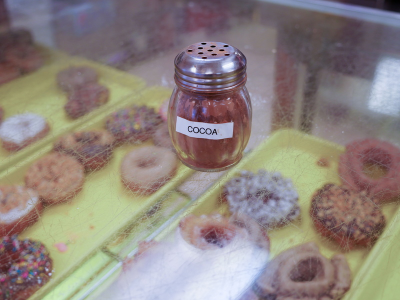 flavor, glass, chocolate, dispenser, western script, donut, donuts, still life, sitting, high angle view, indoors, granulated, sweet, dessert, no people
