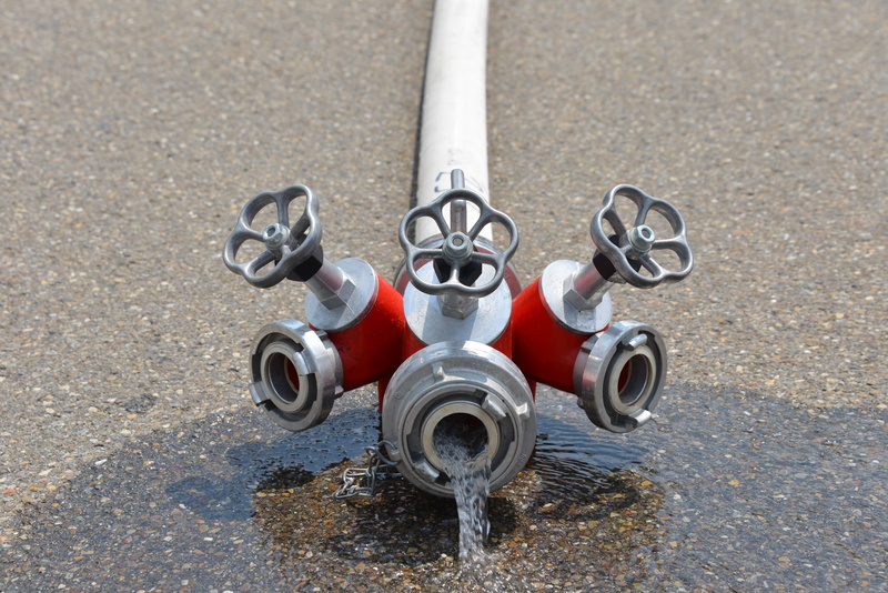 pavement, connection, water pump, fire truck, fire fighting, machine valve, water, use, combustion, high angle view, security, no people, equipment, outdoors