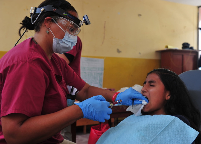 indoors, females, patient, Dentist, cleans, people, protective workwear, mature men, teeth, doctor, injecting, hospital, girl, Dental, mid adult, emergency services occupation