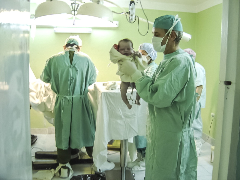 responsibility, group of people, holding, adult, pediatric, men, medical, baby, surgical cap, inside, surgical mask, room, indoors, hospital, mature men
