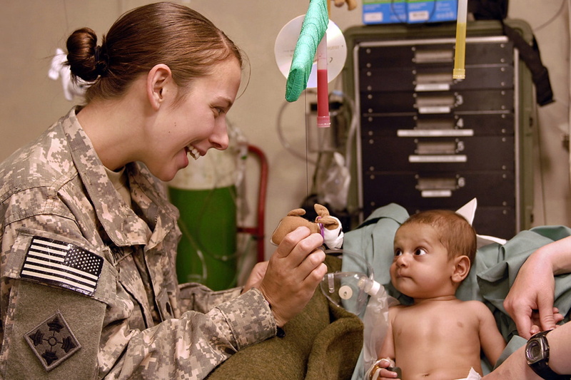 baby, people, kid, holding, hairstyle, healthcare, marines, indoors, sitting, care, health, soldier, childhood, emotion, female, camouflage, camouflage Clothing