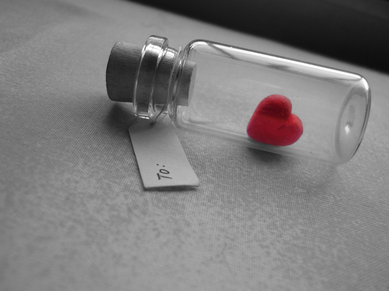 single Object, heart shape, love, vial, two objects, glass - material, table, concepts, positive emotion, tag, bank, high angle view, valentines day - holiday