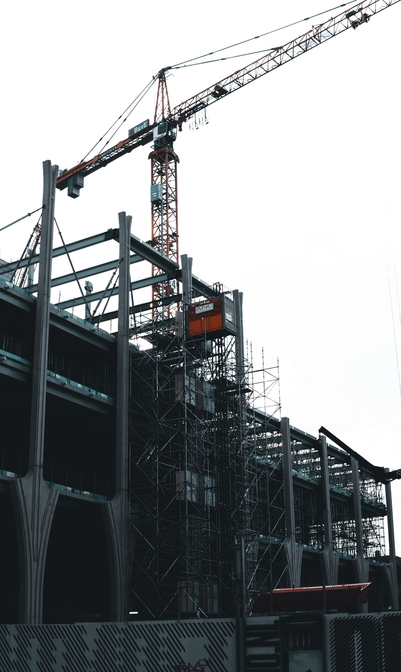 city, building, apparel, incomplete, power plant, helmet, nature, clear sky, building exterior, construction equipment, crane - construction machinery