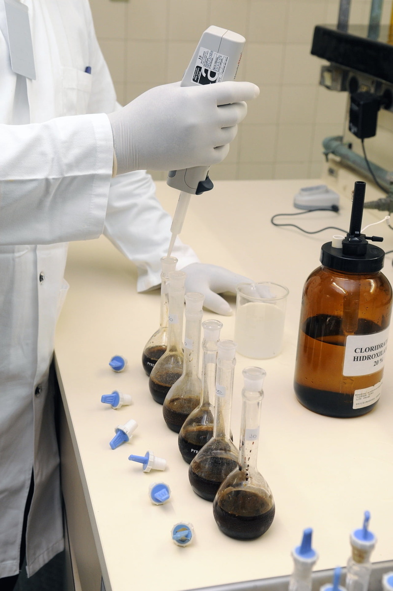 one person, clinical examination, science, scientist, flasks, analyzing, laboratory, chemistry, holding, bottle, container, filling, lab coat, medicine