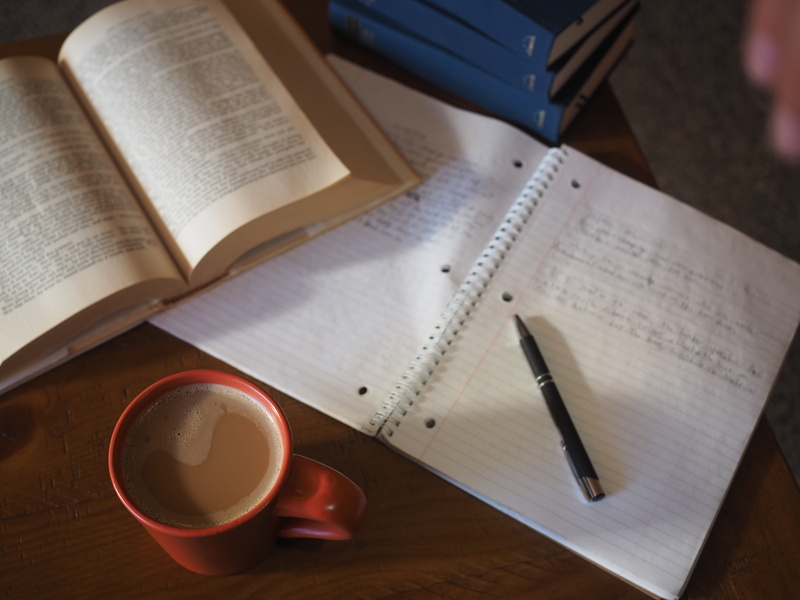 study, high angle view, homework, notebook, page, drink, no people, school, coffee shop, coffee cup, literature, still life, book, close-up, pen, coffee