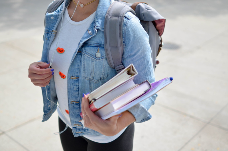 college, books, left, education, planner, university, midsection, standing, headphone, publication, woman, person, young women, organization, young adult