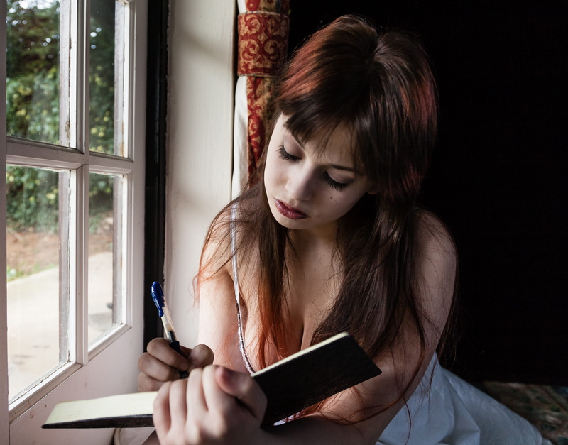 pretty, looking down, female, young, teenager, ballpen, connection, book, technology, beautiful woman, sitting, organizer, records, write, sit, adolescent