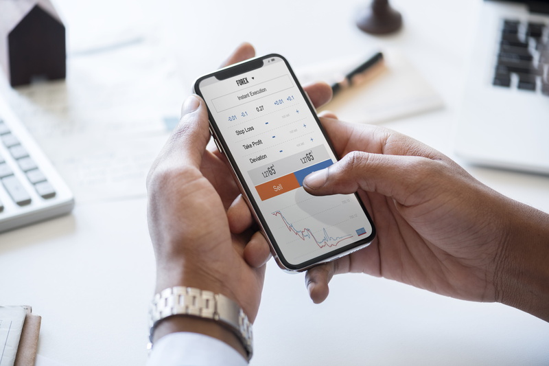 america, businessman, german, daily, device, english, paper, website, iphone, human body part, stock, checking, caucasian, one person, data, investment