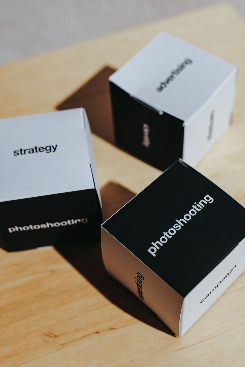 paper, box, high angle view, passport, advertising, no people, words, wood - material, identity, cardboard, focus on foreground, two objects, black color