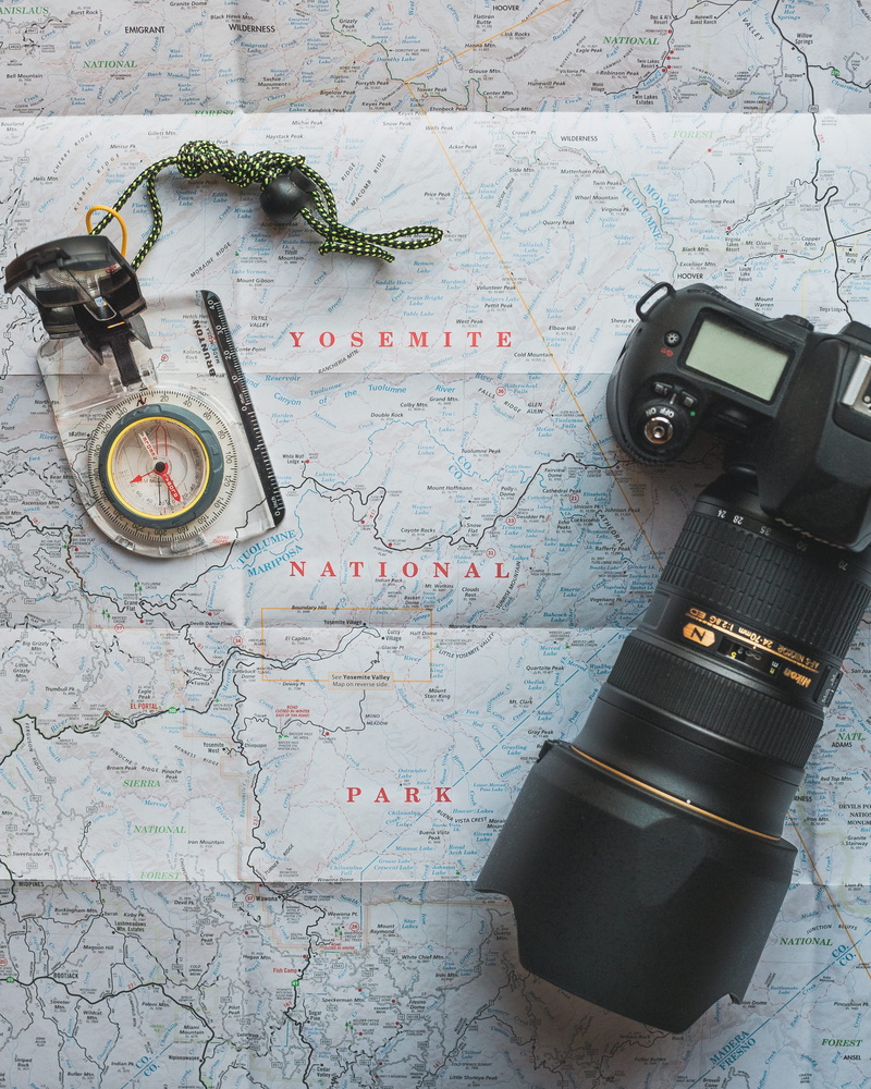 black, close-up, world map, exploration, camera - photographic equipment, lens, still life, map, communication, camera, day, dslr, holiday, technology