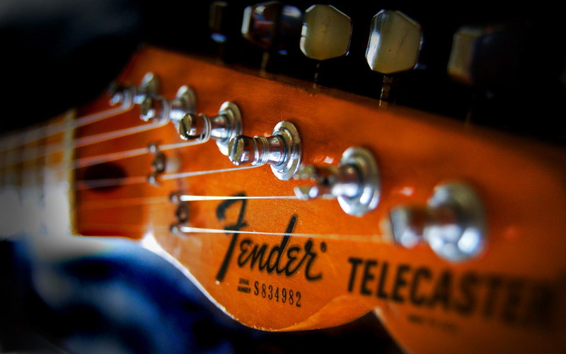 no people, selective focus, amplifier, violin, brown, indoors, 720P, focus on foreground, head, musical instrument, string, guitar, headstock, skill, close-up