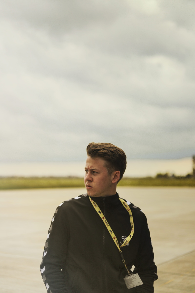 yellow, photoshoot, black, outdoors, man, real people, standing, black jacket, photo, away, young adult, cloud - sky, contemplation, day, waist up, nature