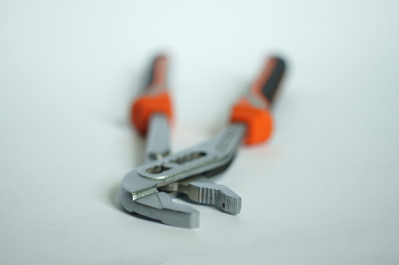 two objects, black, close-up, table, pliers, still life, pincers, no people, copy space, tool, focus on foreground, single object, group of objects, orange