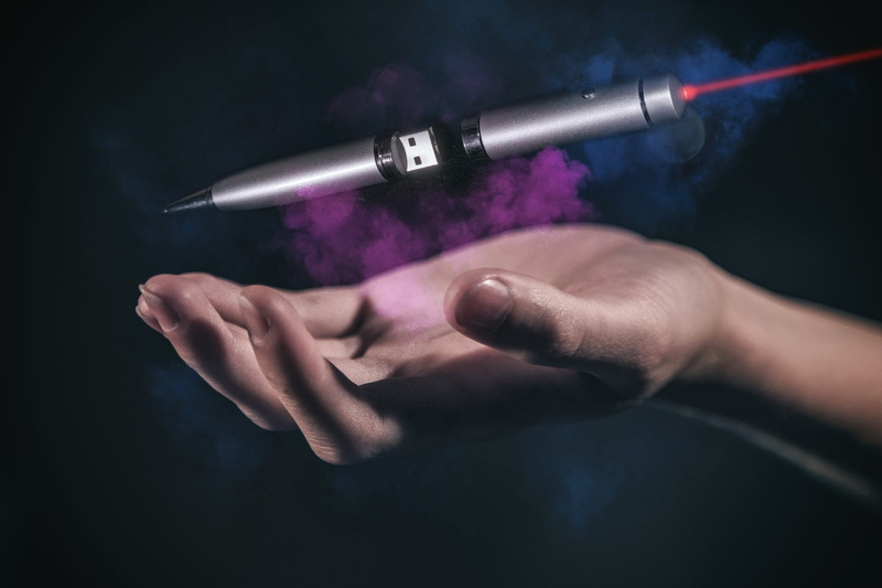 art and craft, holding, care, usb, sport, young adult, close-up, colored background, laser, one person, equipment, pen, human body part, technology, hand