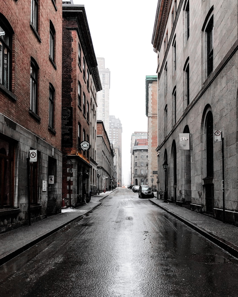daytime, alley, building, rain, road, white, person, wet, standing, montreal, beside, architecture, no people, sidewalk, car, minimal, built structure