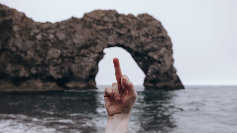 hand, formation, nature, right, human body part, middle, person, lifestyles, front, sky, sea, rock, human hand, outdoors, water, rock - object, human finger