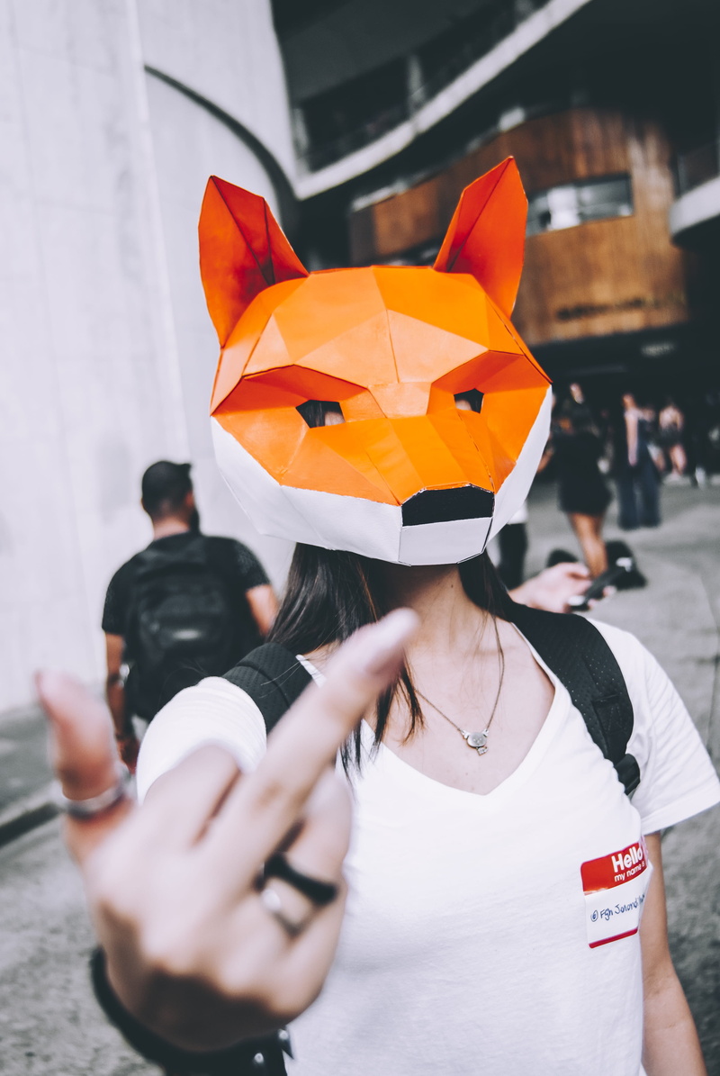 middle finger, portrait, adult, men, finger, waist up, front view, focus on foreground, 4K, woman, real people, day, lifestyles, fox, headdress, focus
