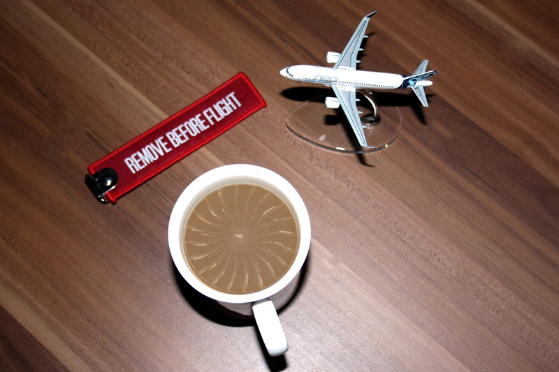 still life, food, high angle view, coffee foam, plane lover, 3d model, western script, red, toy, day, refreshment, transportation, white, brown, food and drink