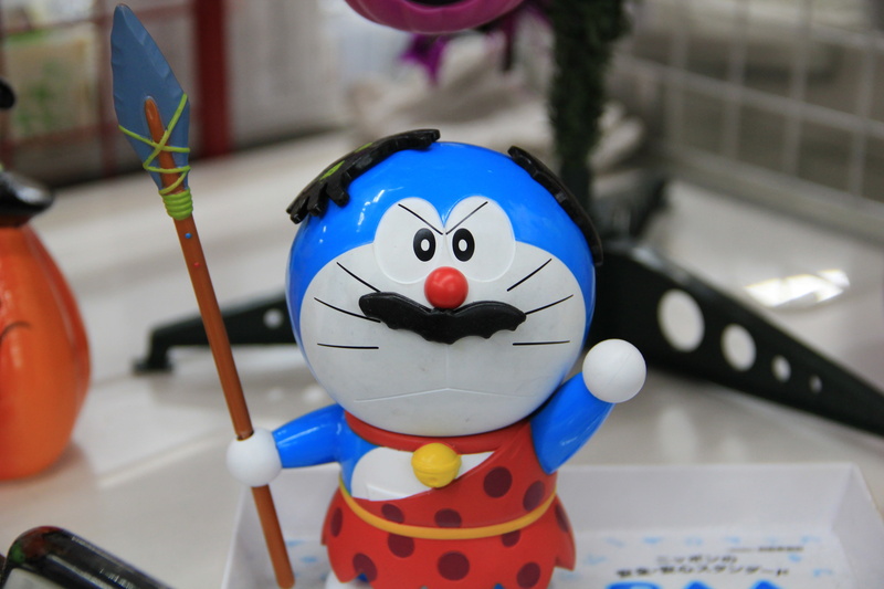 table, doraemon, manga character, focus on foreground, 5K, indoors, art and craft, close-up, manga, robotic cat, still life, craft, male likeness, anime character