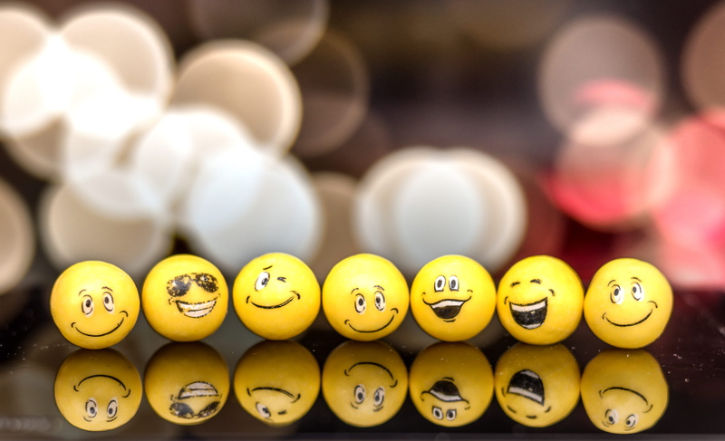 sphere, indoors, close-up, food and drink, in real life, selective focus, confectionery, sweets, yellow, no people, food, expression, emoji, reflection