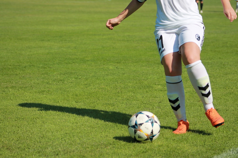 sock, grass, human leg, sports clothing, ladies football, team sport, human body part, football boots, ball, football player, low section, womens football