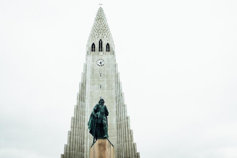 city, hallgrimur, coat, built structure, reykjavik, human, outdoors, spire, tourism, lighthouse, clock, skyscraper, day, building, building exterior, low angle view