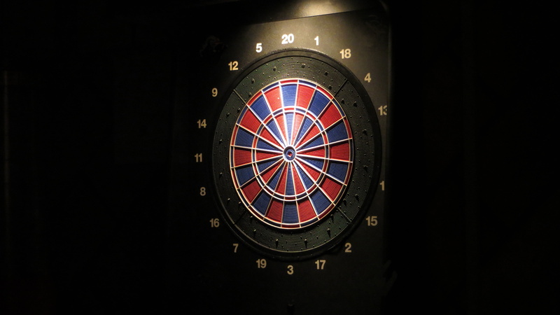 indoors, dartboard, no people, bulls eye, red, leisure activity, dart, round, darts, arts culture and entertainment, leisure games, black color, black