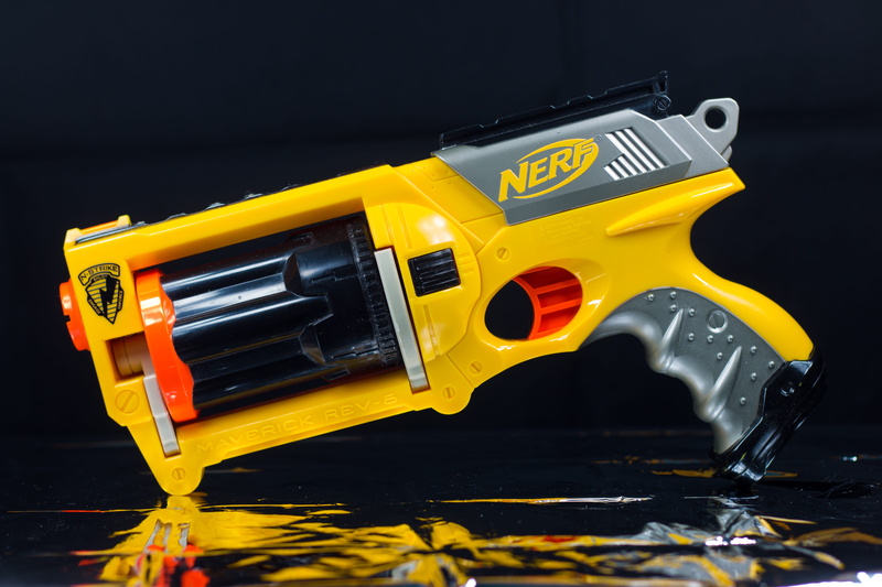 gun, equipment, dart gun, yellow, musical instrument, plastic, arts culture and entertainment, toys, indoors, mode of transportation, black background