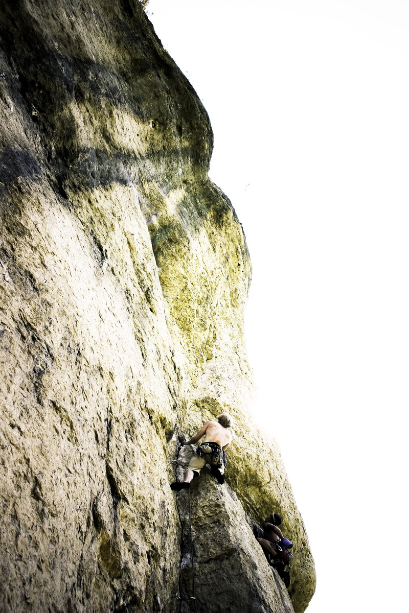 low angle view, cliff, rock climbing, climb, arch, height, extreme sports, activity, beautiful, adult, climber, clear sky, bouldering, effort, formation