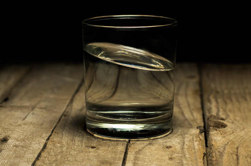 peaceful, drink, wooden, drinking glass, studio shot, through, close-up, transparent, glass, tilted, liquid, single object, no people, tipping, see, food and drink