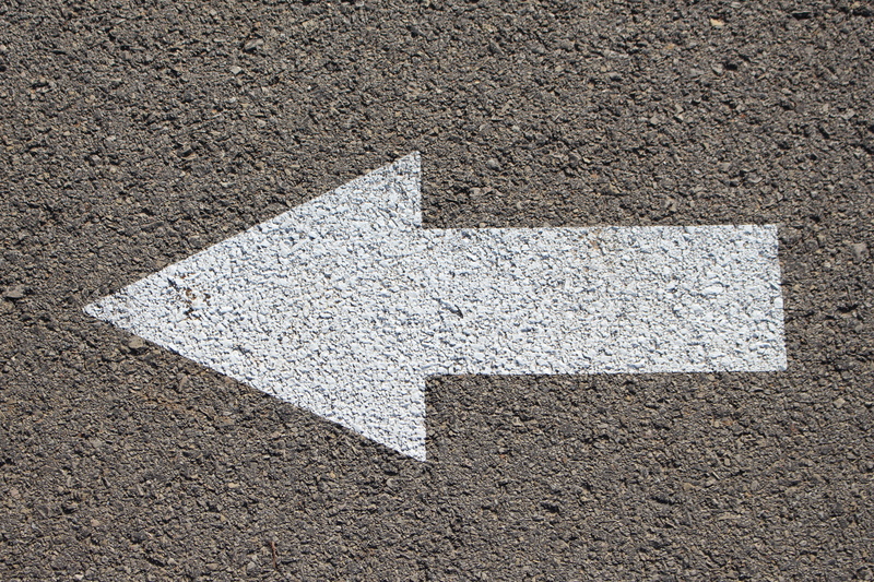 road, asphalt, arrow Symbol, high angle view, pointing, outdoors, directional sign, transportation, concrete, close-up, road sign, painted, architecture