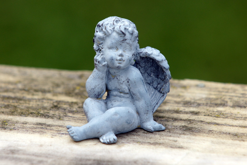 selective focus, outdoors, angel figure, reflection, statue, creativity, sculpture, day, memory, human representation, grabschmuck, harmony, art and craft