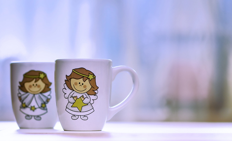 creativity, still life, indoors, art and craft, coffee - drink, cute, angel figure, representation, tea cup, close-up, focus on foreground, mug, blue, table